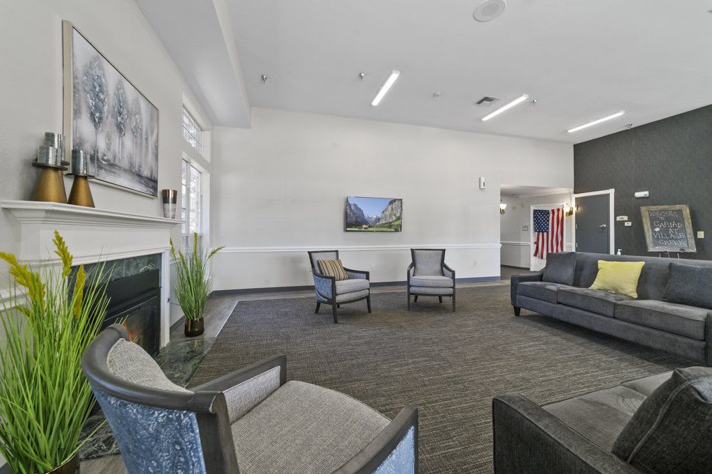 A spacious and well-lit living room with comfortable seating and tasteful decor.