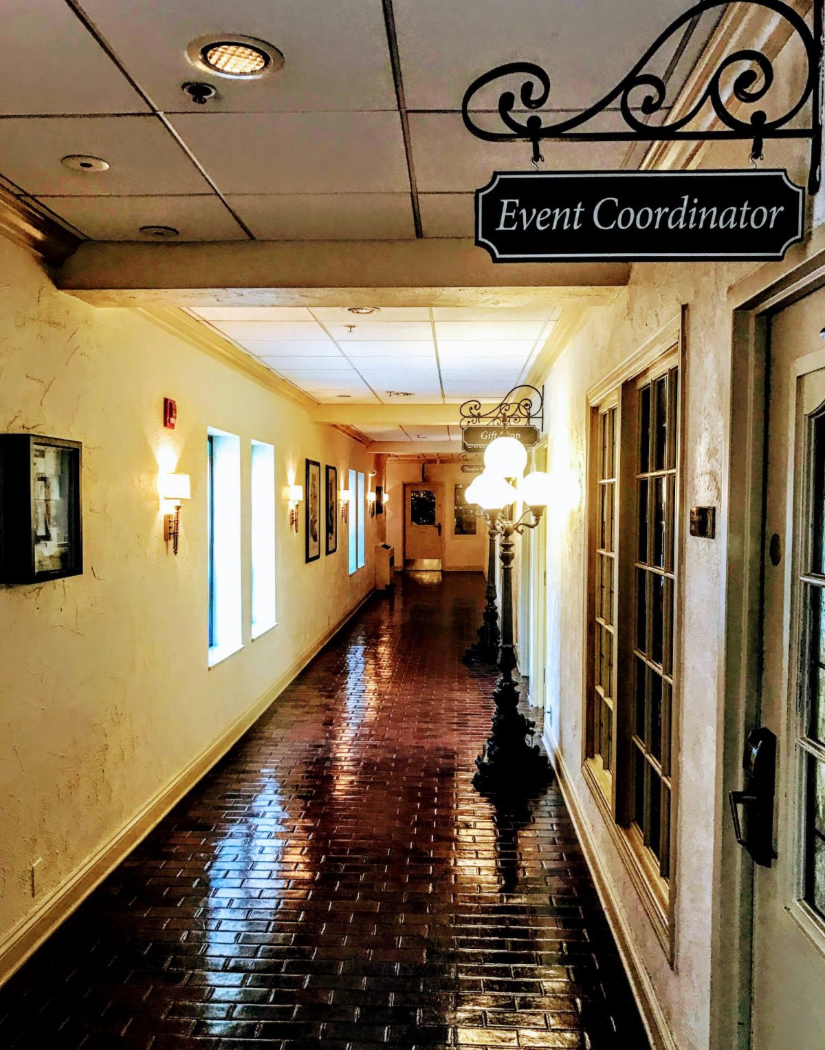 A well-lit hallway with an 'Event Coordinator' sign on the door.