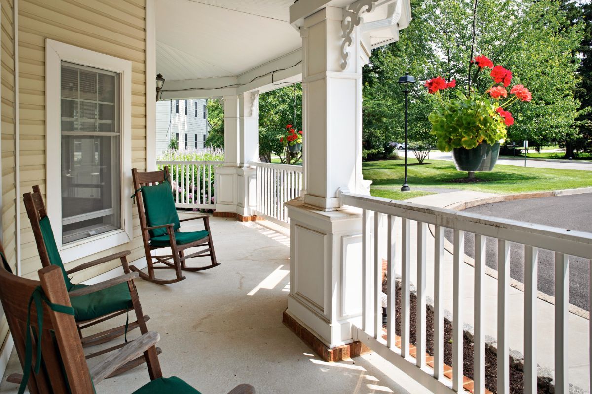 A cozy porch with rocking chairs overlooking a garden.