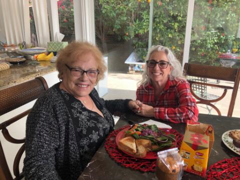 Two women enjoying a meal together indoors.