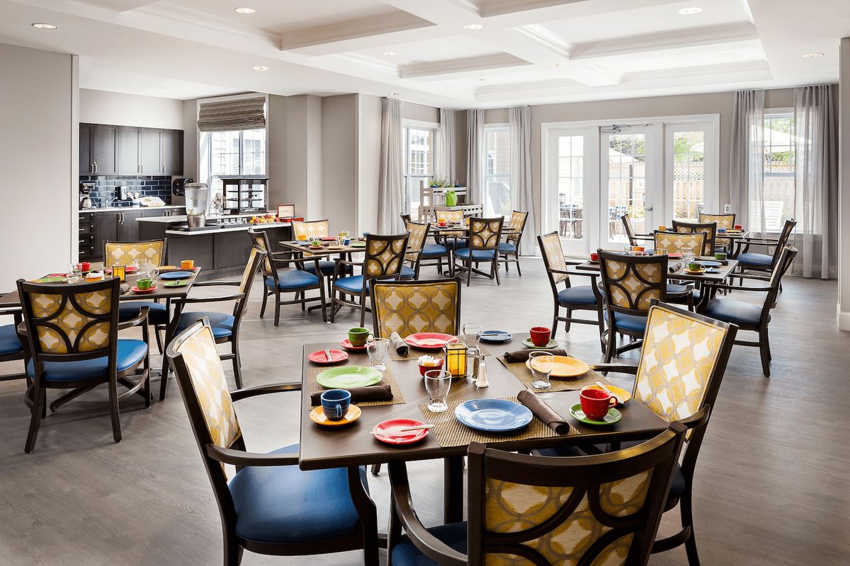 A modern dining area with neatly arranged tables and chairs, ready for guests.