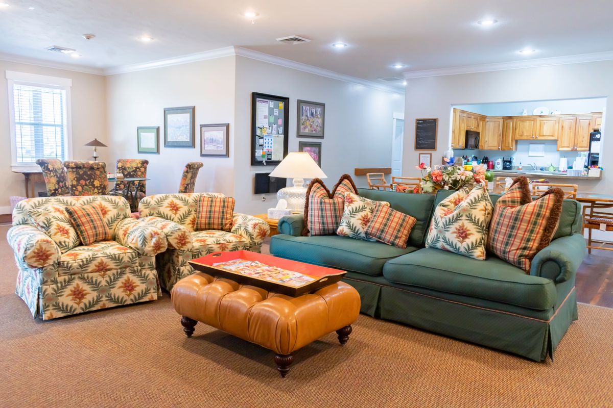 A cozy living room with patterned furniture and warm lighting.