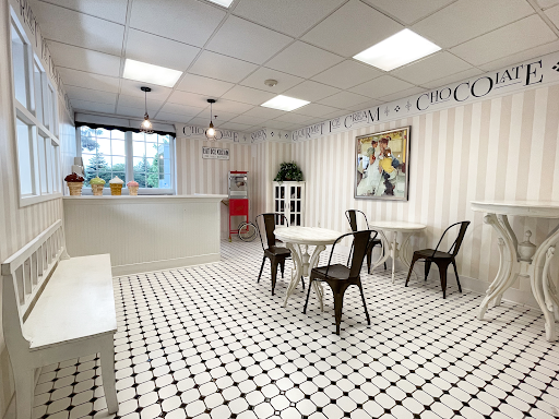 A modern dining area featuring a minimalist design with black and white tiled flooring.