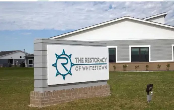 A building exterior with a sign reading 'The Restoracy of Whitestown.'