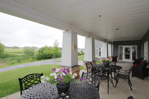 A serene outdoor patio adorned with blooming flowers and elegant furniture, perfect for relaxation amidst nature.
