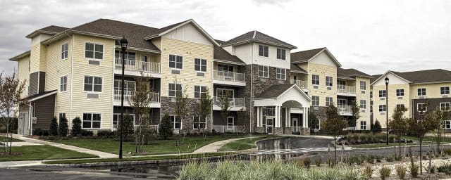 A modern apartment complex with multiple stories and balconies.