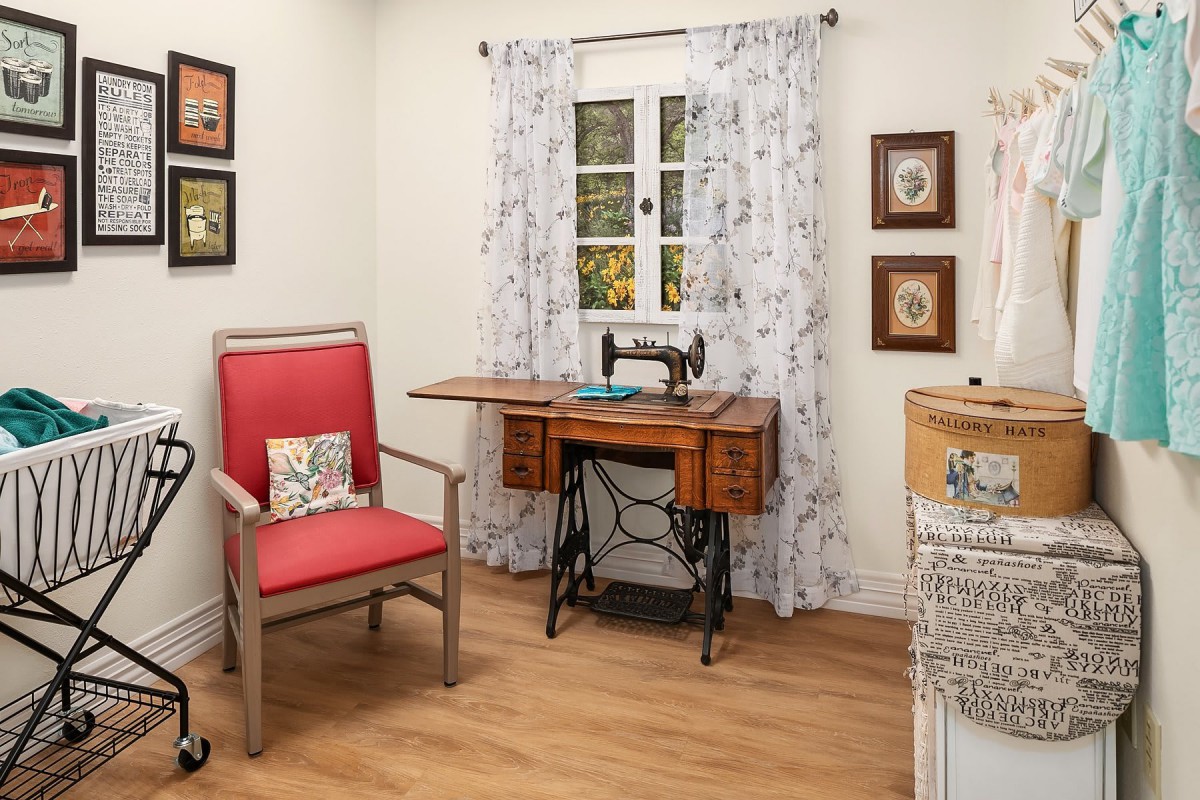 A cozy craft room featuring a vintage sewing machine and warm wooden accents.