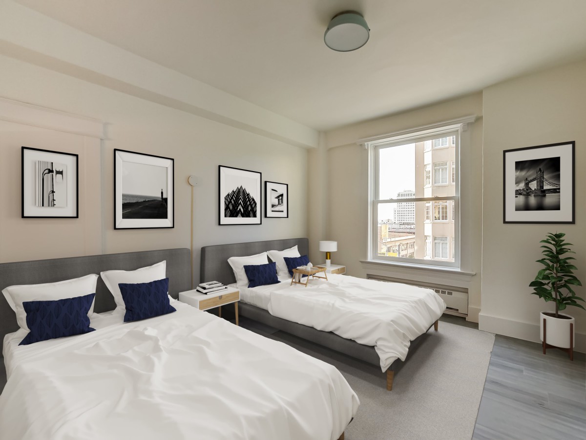 A modern bedroom with two twin beds, featuring neutral tones and artistic decor.