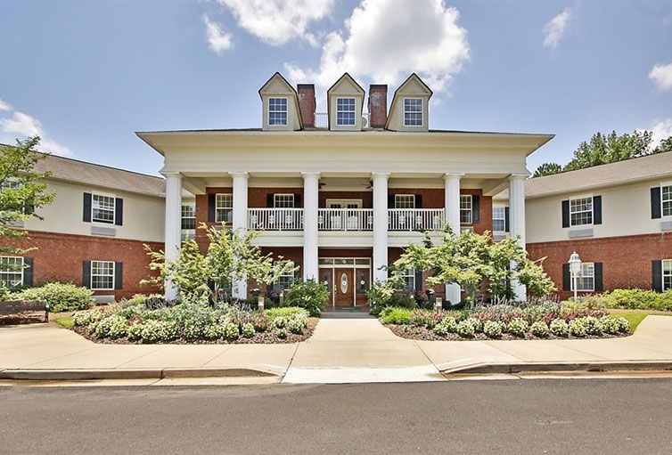 A large colonial-style building with white columns and well-maintained landscaping.
