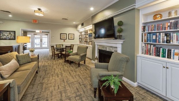 A cozy living room with a fireplace, TV, and comfortable seating arrangement.