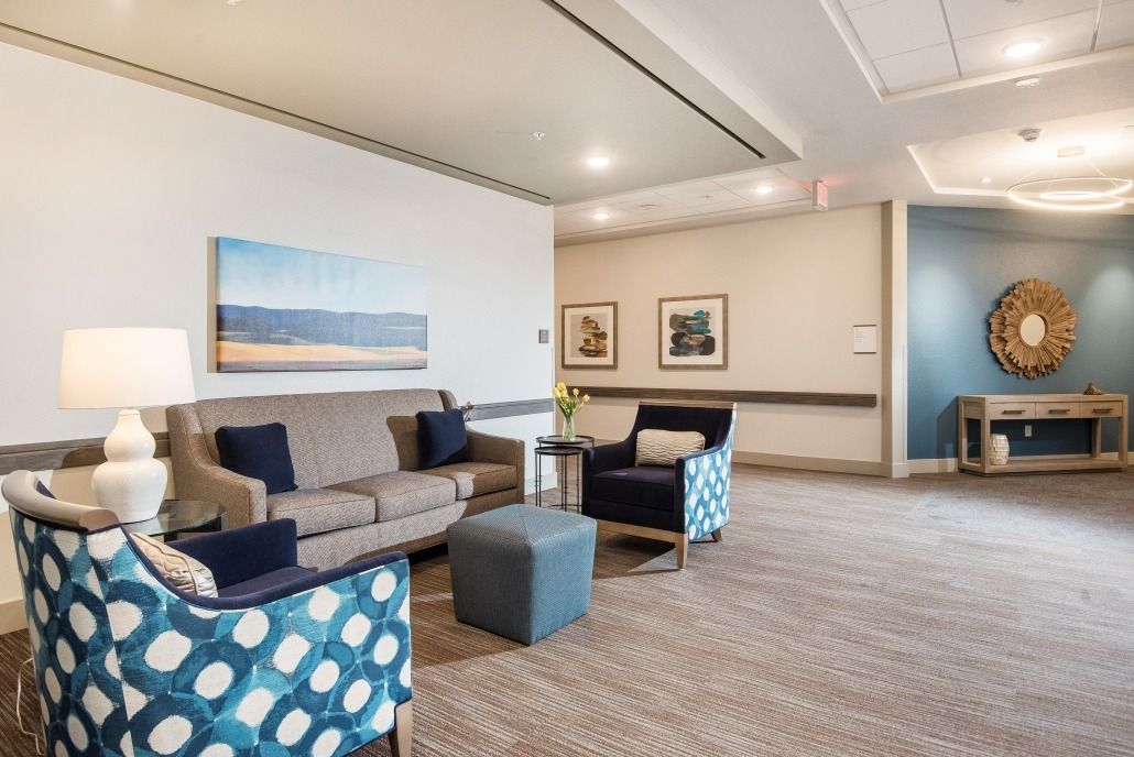 A modern waiting room with comfortable seating and artistic decor.