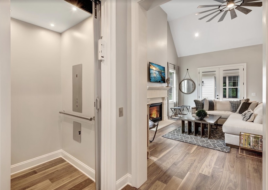 A modern living room featuring an elevator, fireplace, and contemporary design elements.