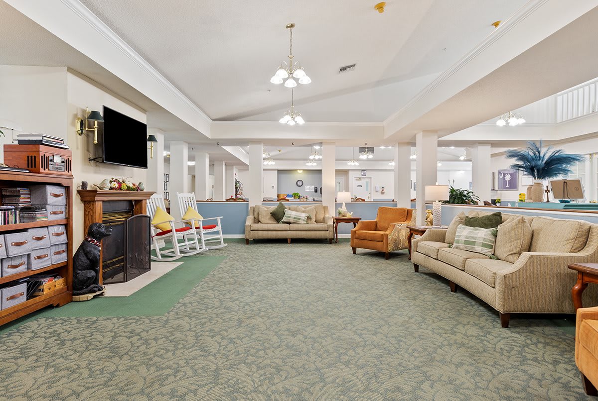 A spacious living room with comfortable seating and a fireplace.