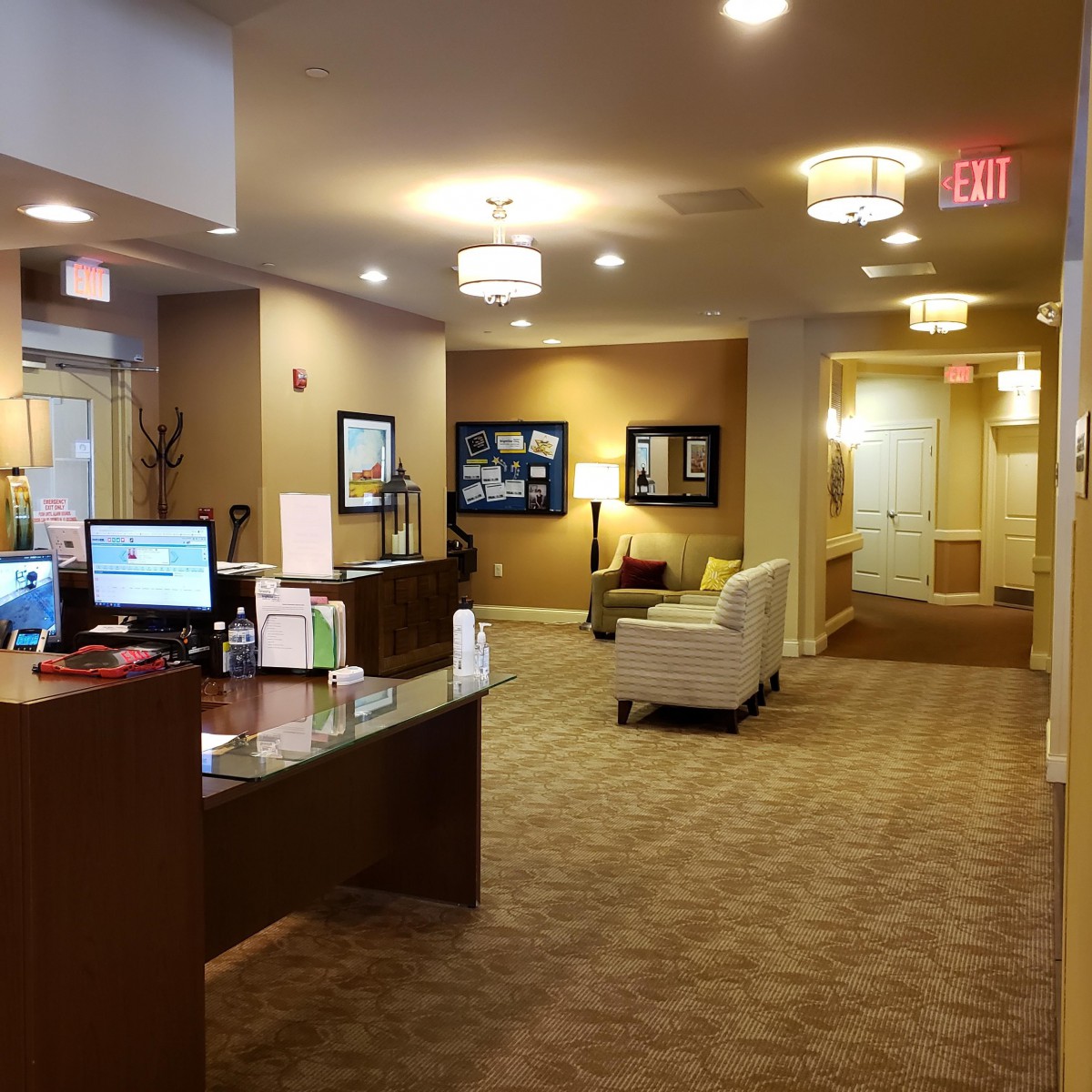 A welcoming office reception area with a desk and seating arrangement.