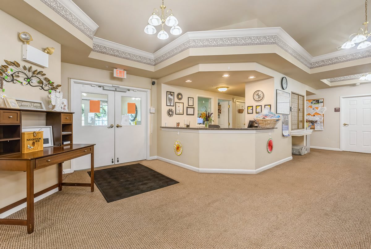 A welcoming reception area with a desk and seating, decorated with framed artwork.