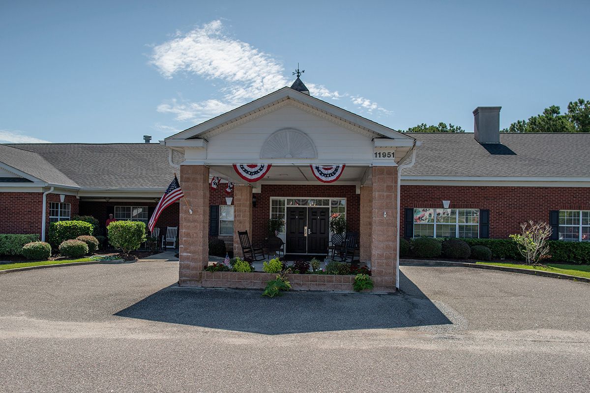 The main entrance of a building decorated with patriotic flags.