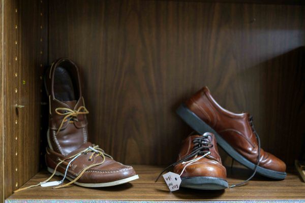 A display of brown leather shoes on a shelf.