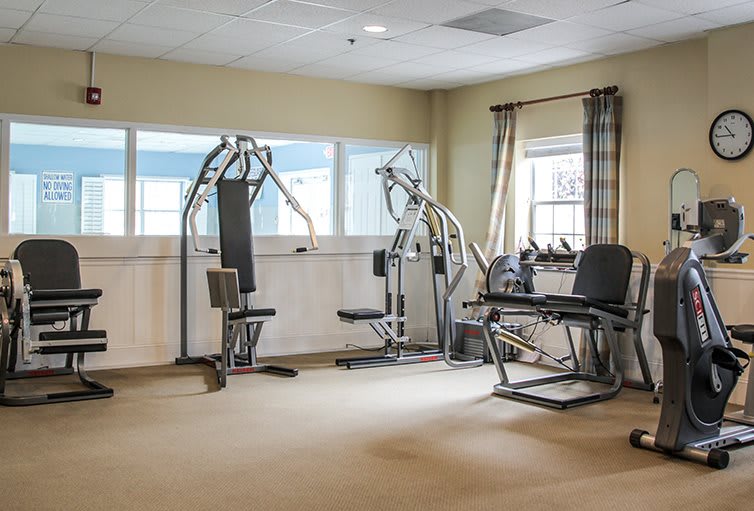 A small gym with various exercise machines and equipment.