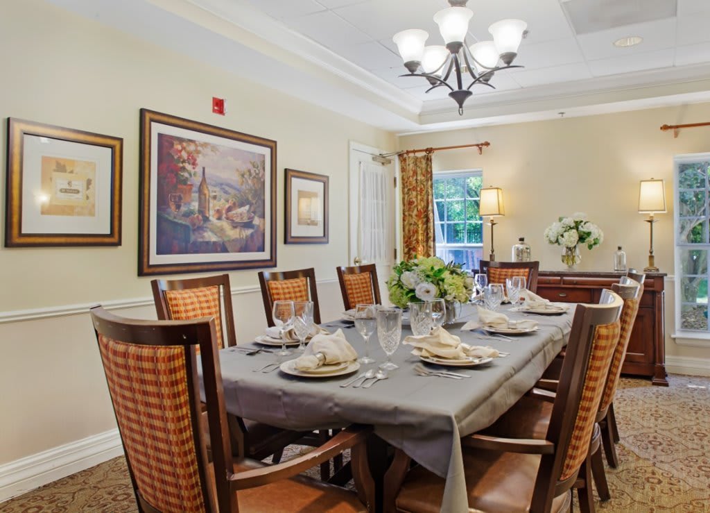 A beautifully set dining room with elegant decor and lighting.