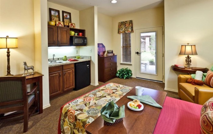 A cozy kitchen and dining area with a table, chairs, and modern appliances.
