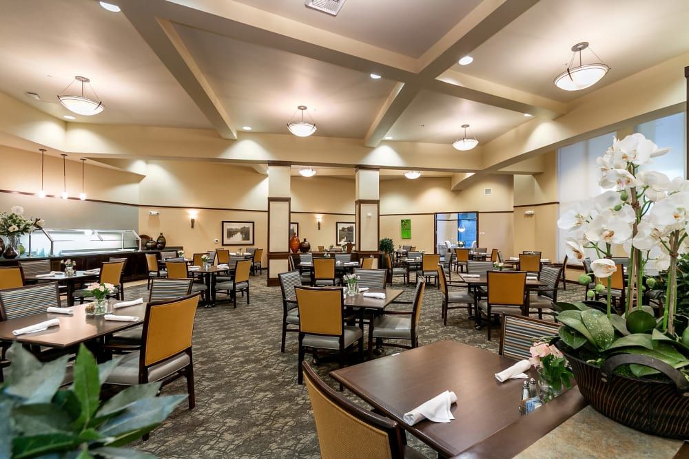 Spacious dining hall with neatly arranged tables and chairs.