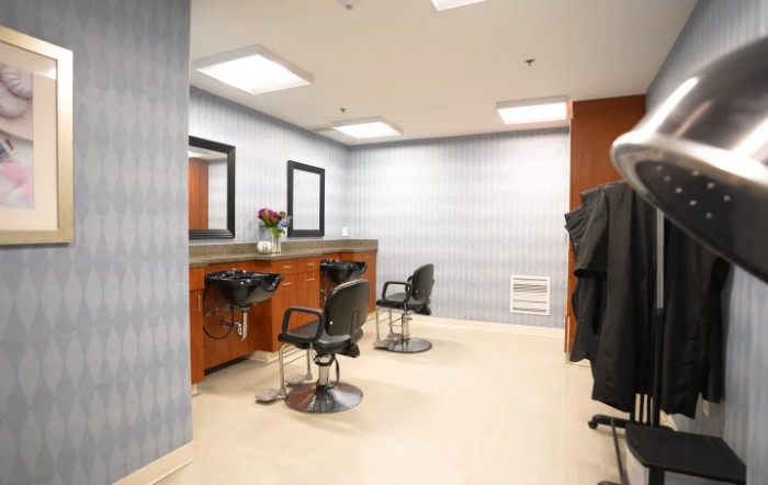 A modern hair salon with styling stations and chairs.