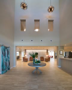 A spacious and elegantly designed lobby area with modern furniture and decor.
