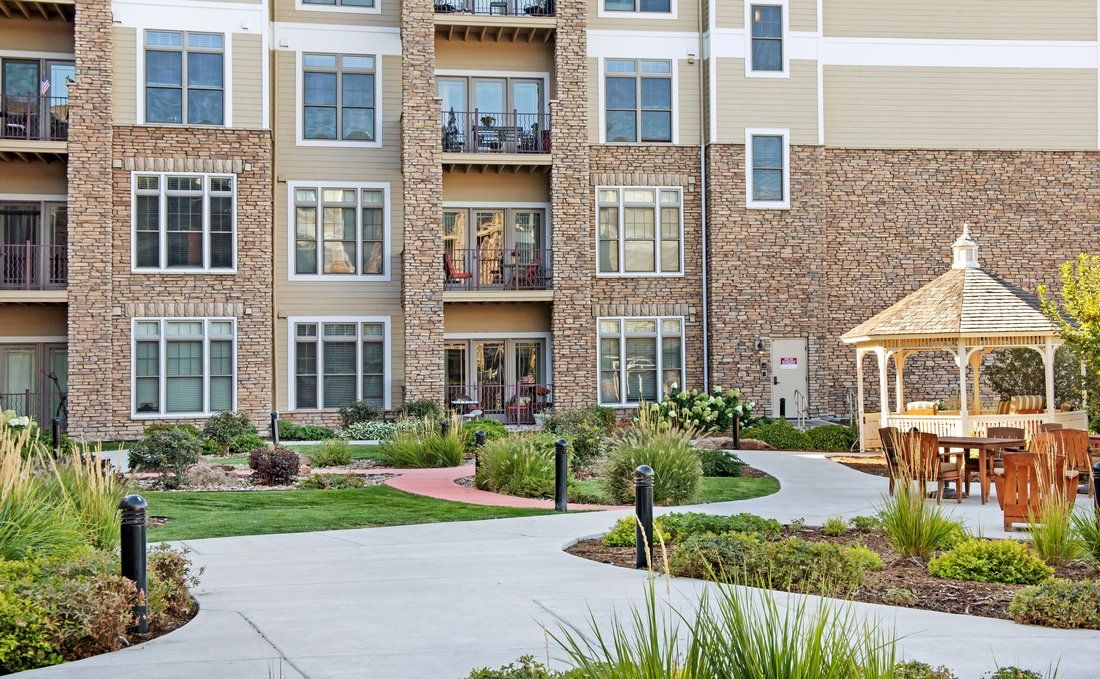 A modern apartment building with well-maintained landscaping and pathways.