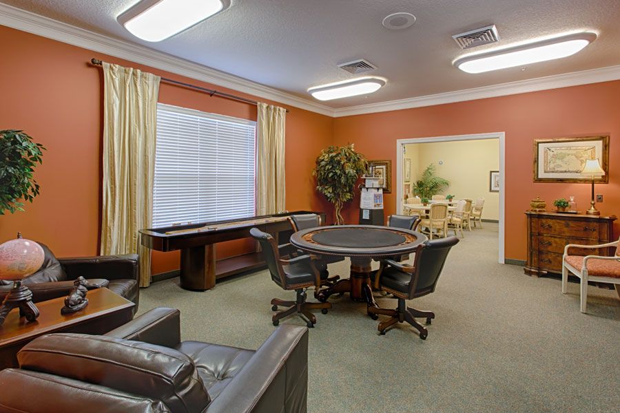 A well-appointed game room featuring a poker table and shuffleboard.