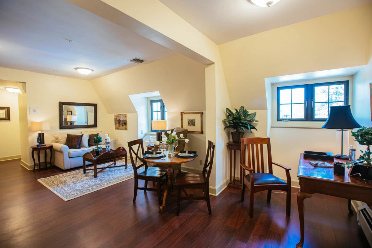A cozy living room and dining area with hardwood floors, comfortable furniture, and tasteful decor.