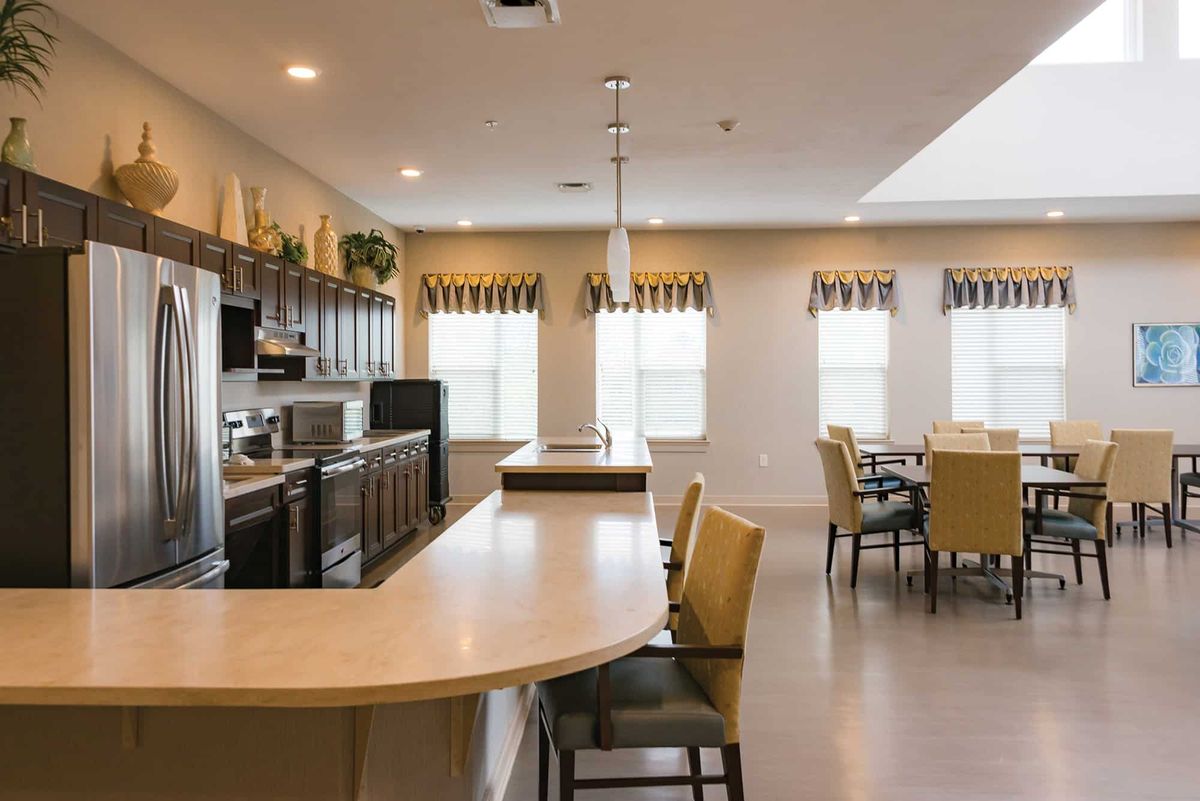 A modern kitchen and dining area with neutral tones and contemporary design.