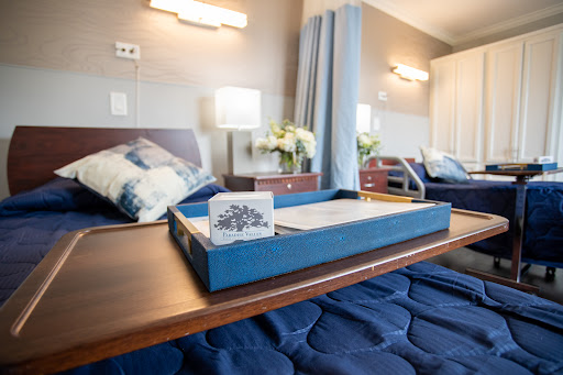 A well-organized hospital room featuring comfortable patient beds and a decorative tray.