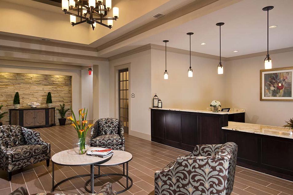 A modern lobby with a seating area, featuring elegant furniture and stylish lighting fixtures.