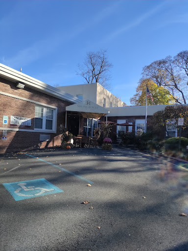 A sunny day at a school, featuring a playground and a welcoming atmosphere.