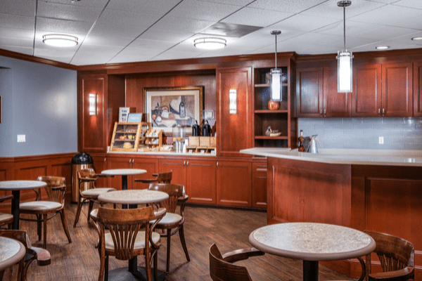 A cozy cafe interior with wooden furniture and a coffee bar.
