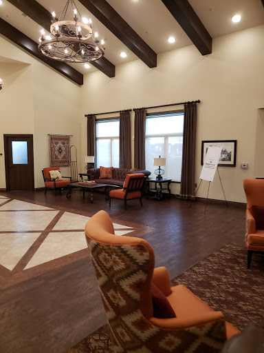 A spacious and inviting lobby featuring comfortable seating, wooden beams, and natural light.