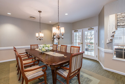 A beautifully arranged dining room featuring a wooden table with elegant chairs and stylish lighting.