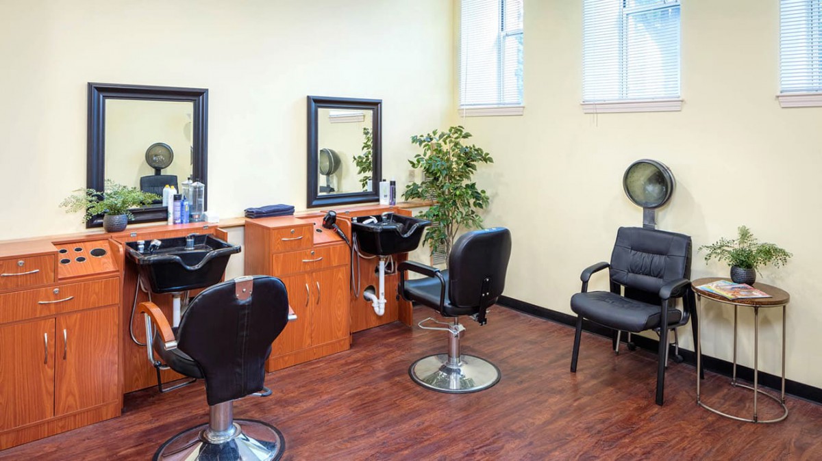 A bright and tidy hair salon interior with styling chairs and mirrors.