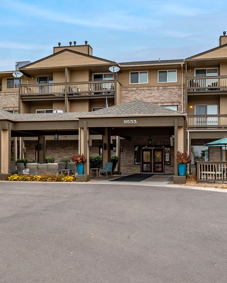 Exterior view of a hotel building with an entrance area and multiple balconies.
