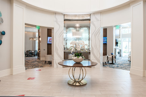 A modern hotel lobby featuring elegant decor and a stylish centerpiece.