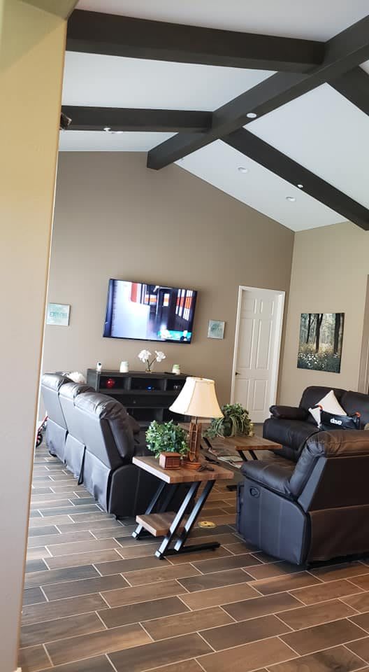 A cozy living room featuring comfortable sofas, a wall-mounted television, and stylish decor.
