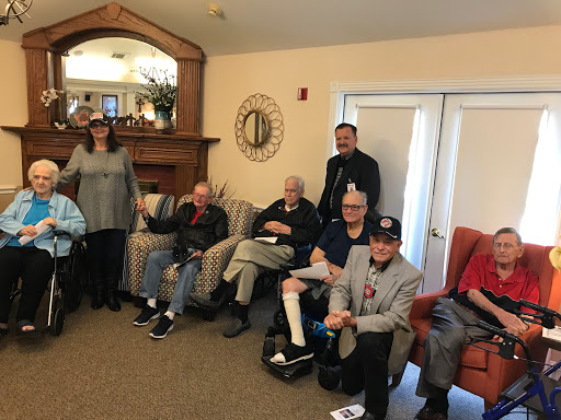 A warm gathering of seniors enjoying each other's company at a community center.