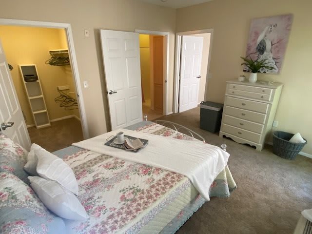 A cozy bedroom with neatly arranged furniture and soft lighting.