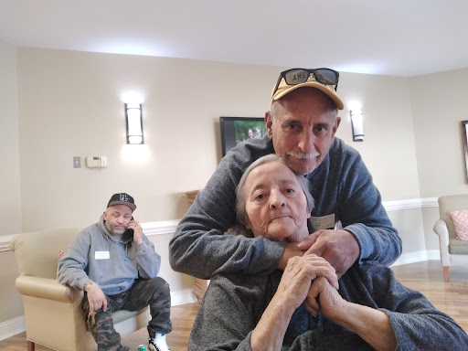 A heartwarming moment of connection between two men in a communal space.