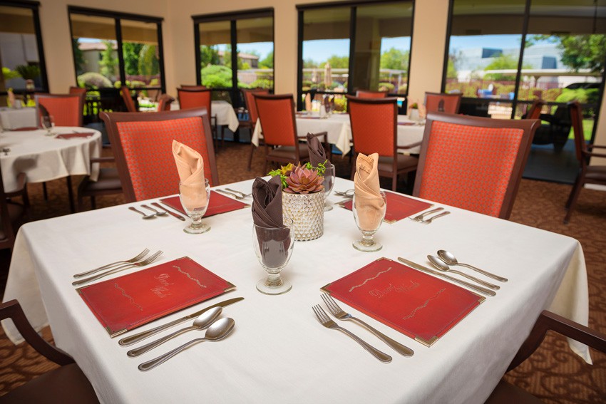 A well-arranged dining table in a formal restaurant setting.
