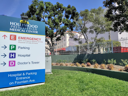 Signage at a medical center indicating emergency and hospital services.