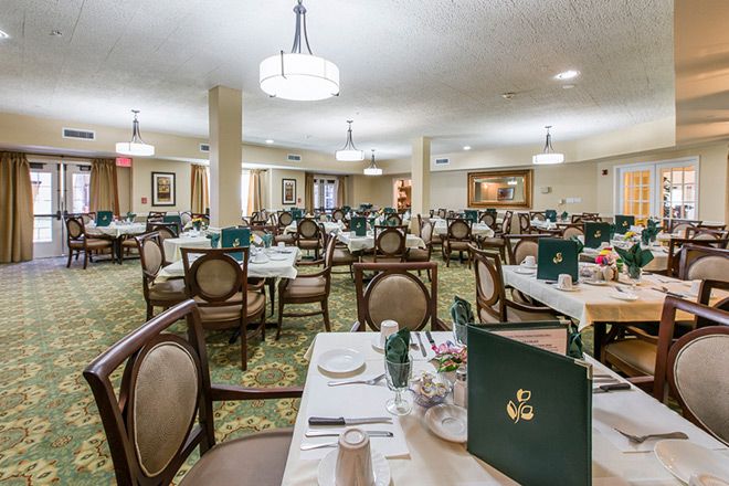 An elegant restaurant dining room with neatly arranged tables and chairs, ready for guests.