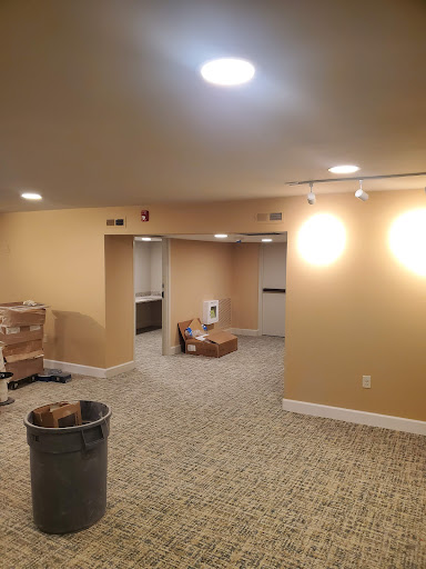 A recently renovated basement space featuring new lighting and fresh paint.