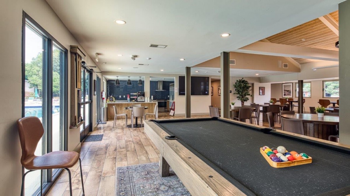 A modern game room featuring a pool table and a bar area, designed for entertainment and relaxation.
