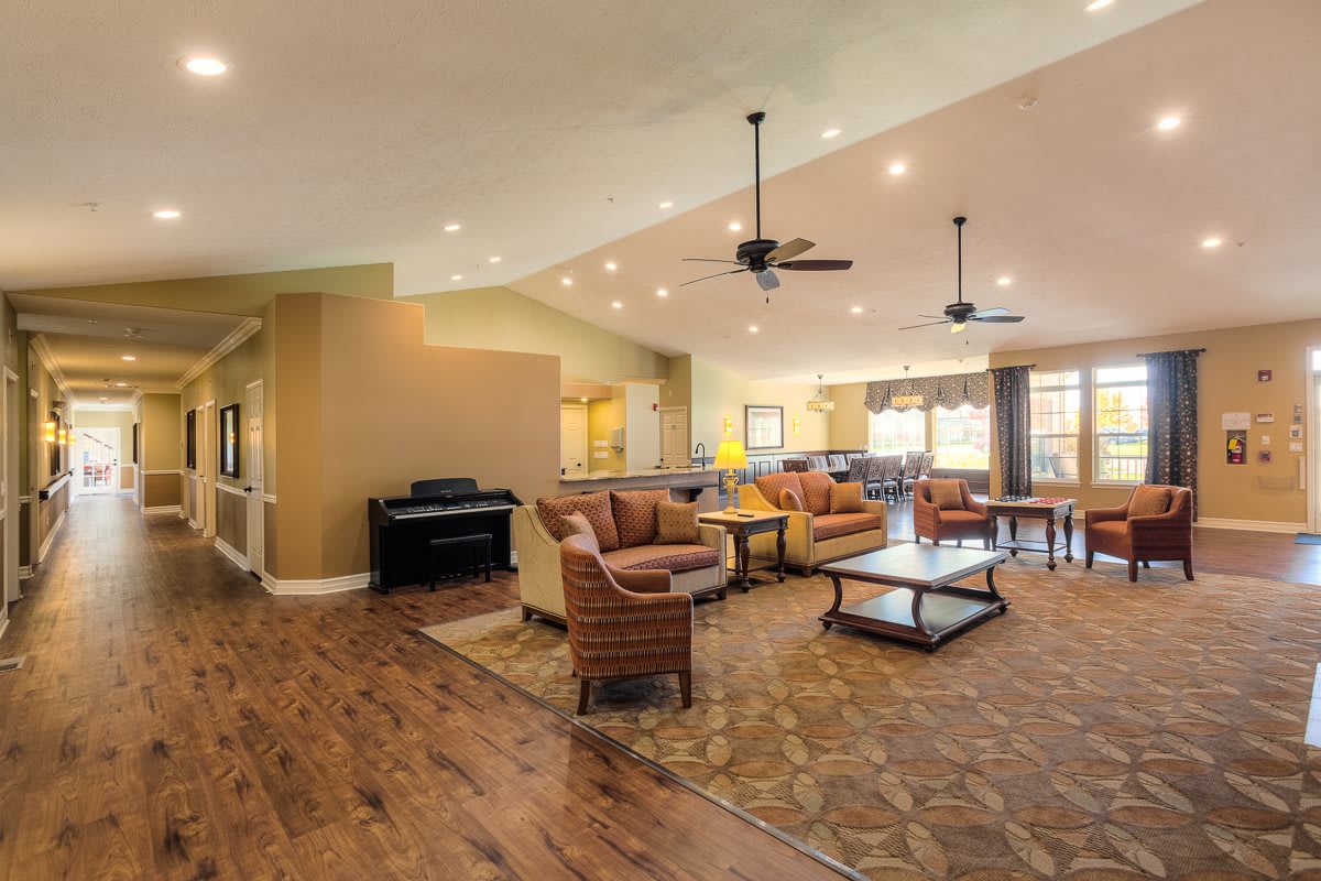 A spacious open-concept living room with wood flooring and modern furnishings.